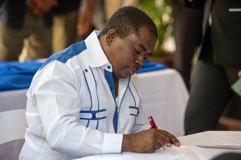 Haitian opposition leader Andre Michel signs a political agreement between the main opposition parties and the Government of Prime Minister Ariel Henry, in a ceremony at his official residence in Port-au-Prince, Haiti, 11 September 2021.