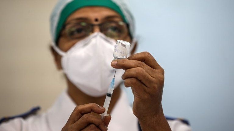 An Indian health worker mocks the vaccination process during a dry run of Covid-19 vaccination inside a Covid-19 vaccination centre at Rajawadi Hospital, in Mumbai, India, 08 January 2021. Acc