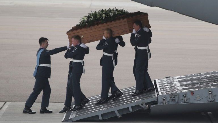 The coffin of Lisa Graham is taken from the RAF C-17 carrying the bodies of nine British nationals killed in the Tunisia terror attack at RAF Brize Norton in Oxfordshire