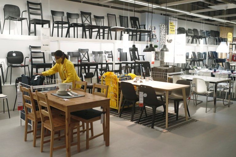 Female employee arranges IKEA display