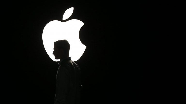 Man in front of Apple logo