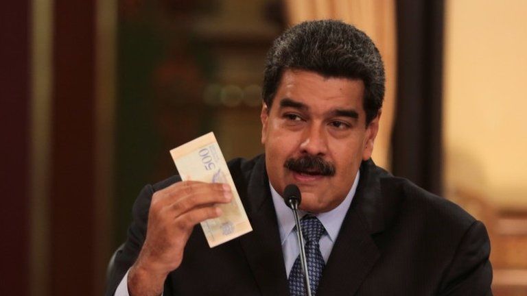 Venezuela"s President Nicolas Maduro holds a bank note from the new Venezuelan currency Bolivar Soberano (Sovereign Bolivar), as he speaks during a meeting with ministers at Miraflores Palace in Caracas, Venezuela August 17, 2018.