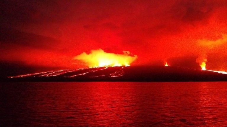 Handout picture released by the Galapagos National Park press service showing lava flowing down the Sierra Negra volcano on Isabela Island in the Galapagos Archipelago about 1000 km off the Ecuadorean coast in the Pacific Ocean, early on June 27, 2018