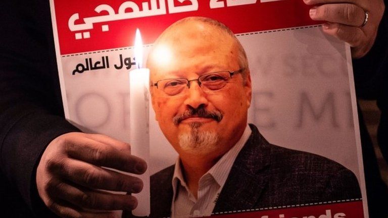 A man holds a poster bearing the face of Jamal Khashoggi