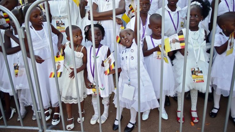 School children wait for Pope Francis' arrival at Lubaga Cathedral in Kampala on November 28, 2015.