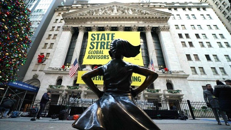 The Fearless Girl statue is unveiled at her new home facing the New York Stock Exchange (NYSE) during an event on 10 December 2018 held by the city of New York and State Street Global Advisors