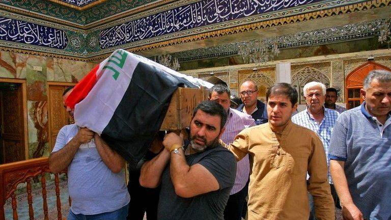 Mourners carry the coffin of a victim of bombing in Baghdad