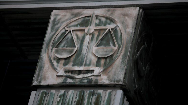 An image of scales is pictured on a pillar of the Supreme Court in Warsaw