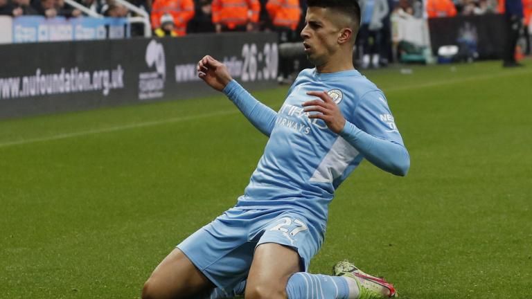 Manchester City's Joao Cancelo heads the ball during the Champions