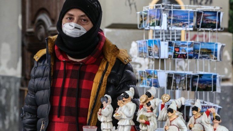 A vendor wears a respiratory mask in Naples