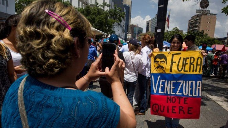 People participate during an event organized by the Venezuelan opposition collecting signatures as part of the process to seek a referendum to remove the president of Venezuela Nicolas Maduro in Caracas, Venezuela, on 27 April 2016.