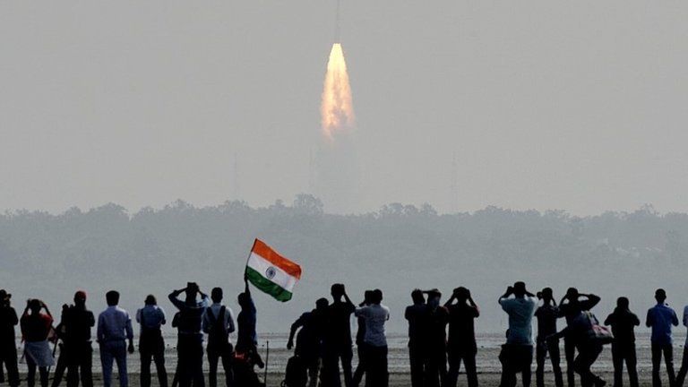 Indian onlookers watch the launch of the Indian Space Research Organisation (ISRO) Polar Satellite Launch Vehicle (PSLV-C37) at Sriharikota on Febuary 15, 2017