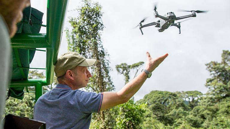 Camera man Eric Huyton releases a filming drone to capture aerial views of the Costa Rican rainforest