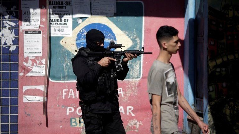 A policeman takes up position during an operation against drug dealers in Cidade de Deus slum in Rio de Janeiro, Brazil, July 10, 2017