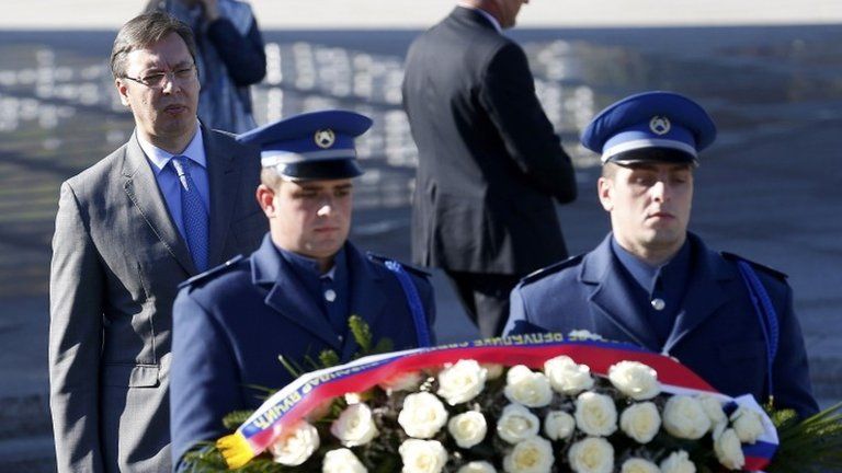 Serbia's Prime Minister Aleksandar Vucic (left) in front of a wreath being laid at the Srebrenica memorial