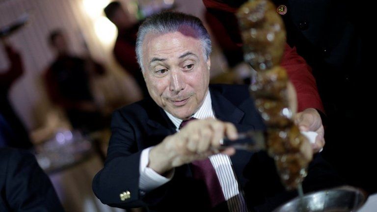 Brazil"s President Michel Temer eats barbecue in a steak house after a meeting with ambassadors of meat importing countries of Brazil, in Brasilia