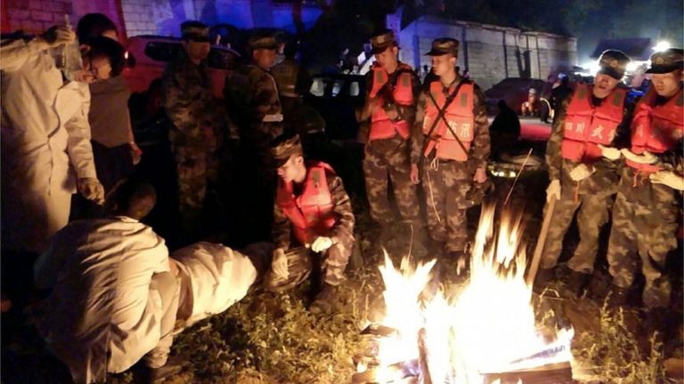 Medics treat a rescued person in Jiuzhaigou