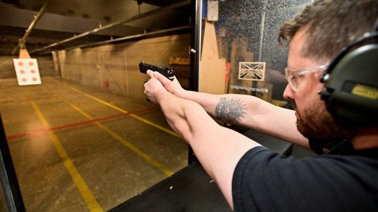 Andrew Trafananko, General Manager of the Range Langley, British Columbia, fires a handgun after Canada's government introduced legislation to implement a "national freeze" on the sale and purchase of handguns, 31 May 2022.