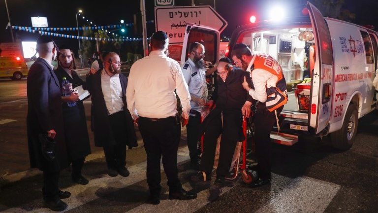Israeli emergency forces evacuate injured ultra-Orthodox Jews after the collapse of seatinge in a synagogue, in the West Bank settlement of Givat Zeev (16 May 2021)