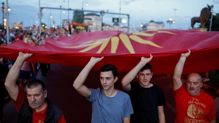 Supporters of opposition party VMRO-DPMNE carry a big Macedonian flag as they take part in a protest opposing a compromise with Greece, on 2 June 2018.