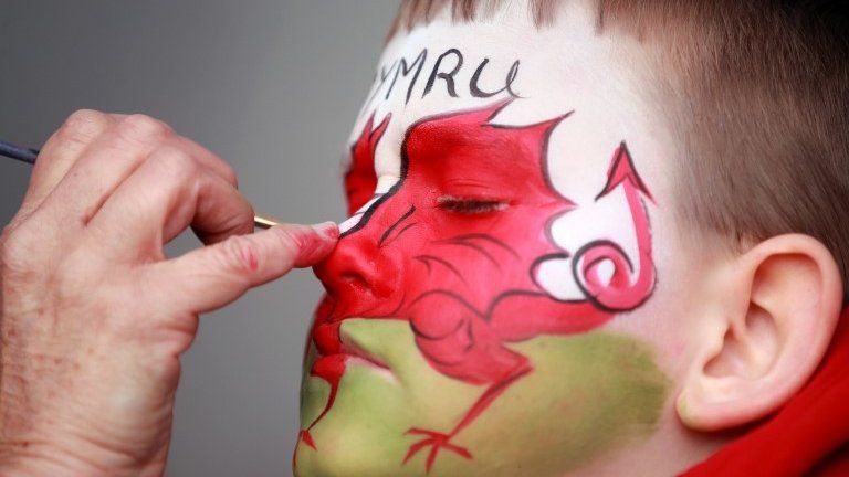 Young fan gets his face painted in Cardiff
