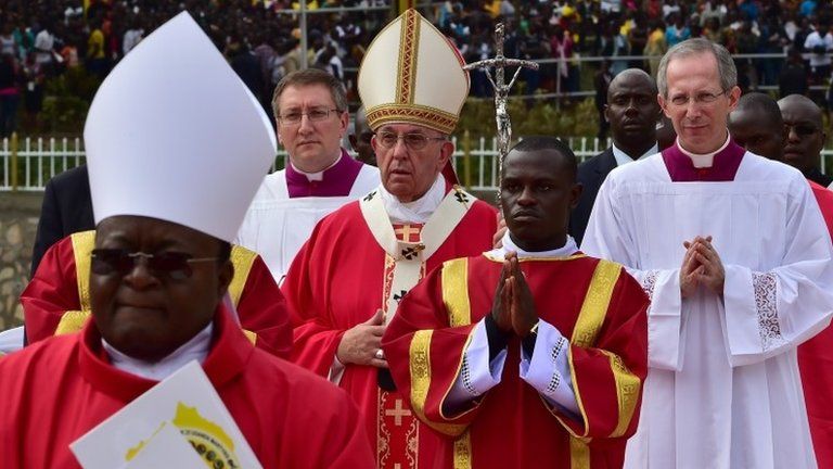 Pope Francis (C) arrives to celebrate an open mass in Kampala, Uganda, on Saturday