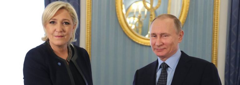French presidential candidate and far-right Front National political partys leader Marine Le Pen (L) shakes hands with Russian President Vladimir Putin (R)