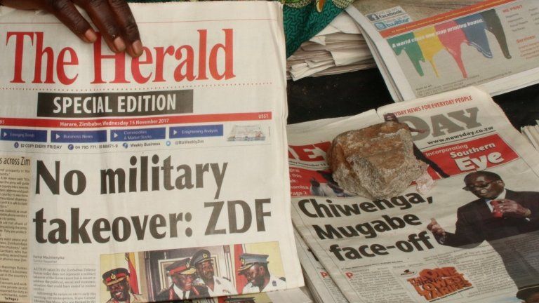 A vendor picks up a copy of a special edition of the state-owned daily newspaper The Herald in Harare, Zimbabwe