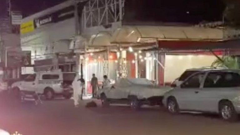 Emergency officials stand outside a bar after gunmen shot dead a journalist early on Sunday in the Mexican city of Iguala in the southwestern state of Guerrero, according to local authorities, August 2, 2020, in this still image taken from video obtained from social media