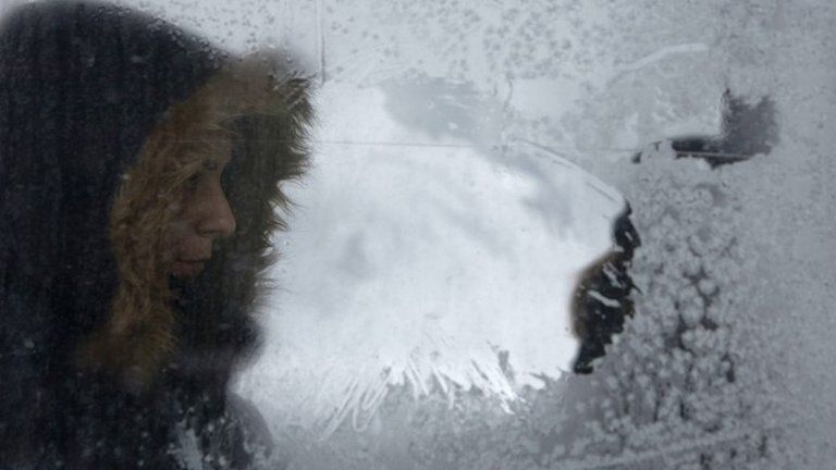 A woman is seen through an icy window on a tram in Sarajevo, Bosnia. Photo: 9 January 2017