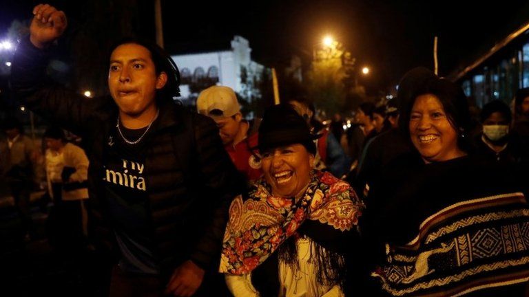 People celebrate on the street after the government of President Lenin Moreno agreed to repeal a decree that ended fuel subsidies in Quito.
