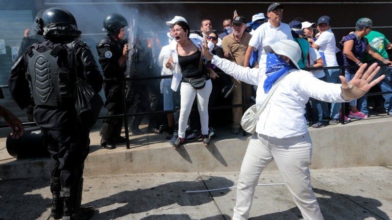 Riot police try to block protesters during a march in Managua, Nicaragua October 14, 2018