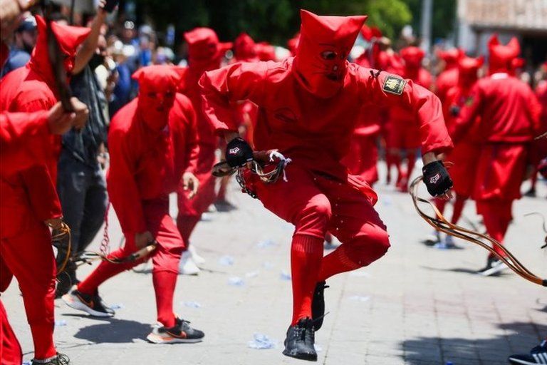 Men dressed as demons participate in a ceremony known as Los Talciguines, as part of religious activities to mark the start of the Holy Week in Texistepeque, El Salvador, April 11, 2022.