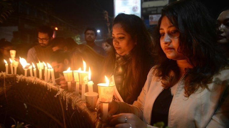 Indian mourners take part in candle light vigil as they pay homage to the killed service members in Siliguri