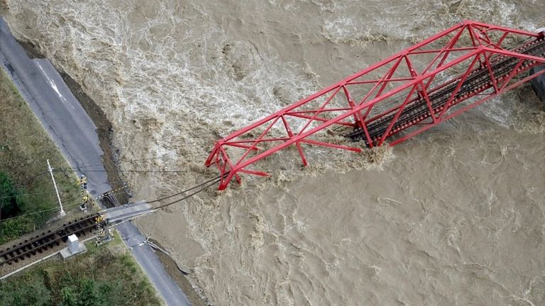 A collapsed railway bridge is seen over Chikuma river swollen by Typhoon Hagibis in Ueda, central Japan, October 13, 2019