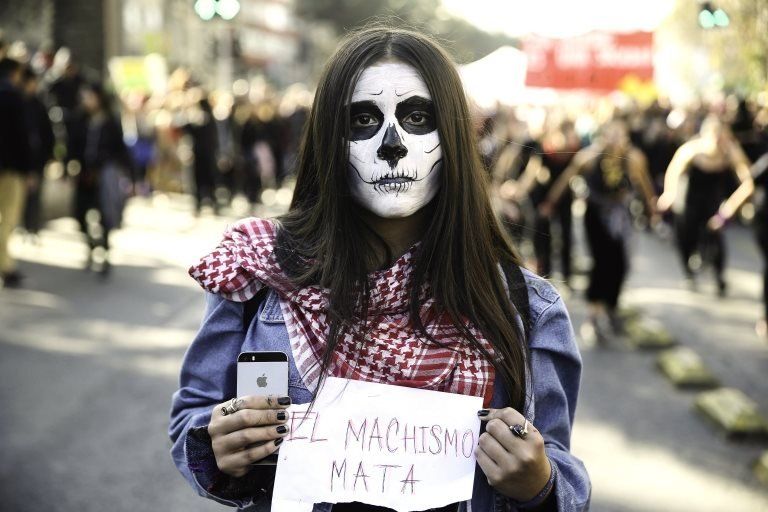 A woman holds a sign that reads "machismo kills" during a demonstration in Santiago, Chile, 06 June 2018.