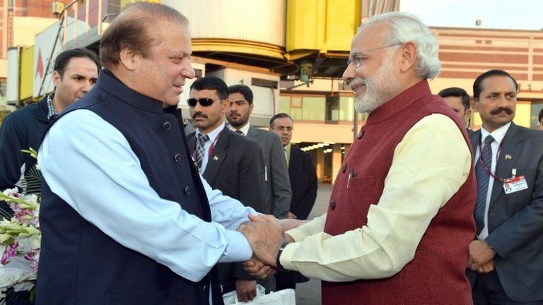 A handout photograph released by the Indian Press Information Bureau (PIB) on 25 December 2015 of Indian Prime Minister Narendra Modi (R) being welcomed by the Prime Minister of Pakistan, Nawaz Sharif (L), at the airport in Lahore, Pakistan, 25 December 2015.