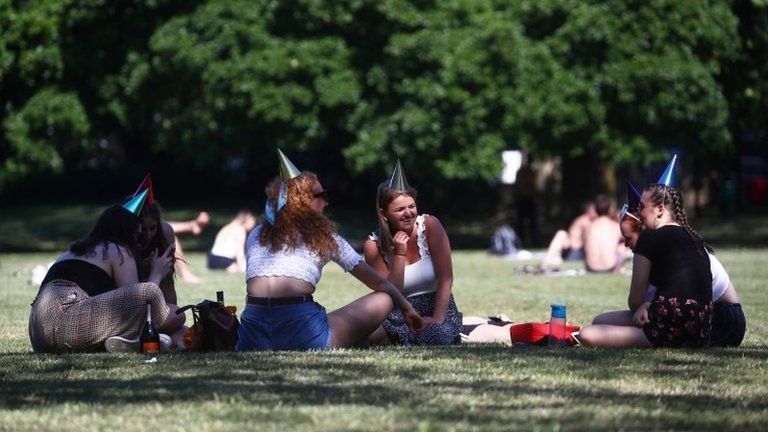 A group of friends enjoy the hot weather in Kennington Park
