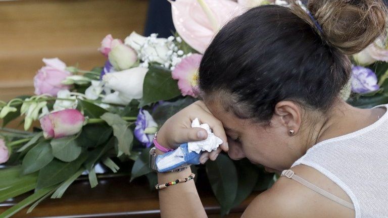 A woman grieves before the funerals of victims of the Italian earthquake, 27 August 2016