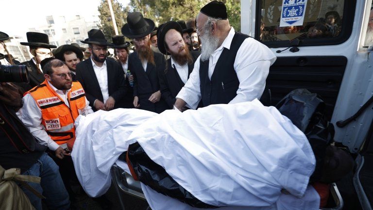 Israeli Ultra-Orthodox mourners attend a funeral after the stampede during at Mount Meron, in Jerusalem