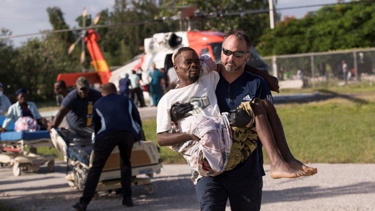 Doctors from the US organization Medic Corps transfer people affected by the earthquake, at the OFATMA hospital, in Les Cayes, Haiti, 18 August 2021