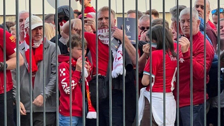 Liverpool fans react as they queue to access Stade de France before Champions League Final