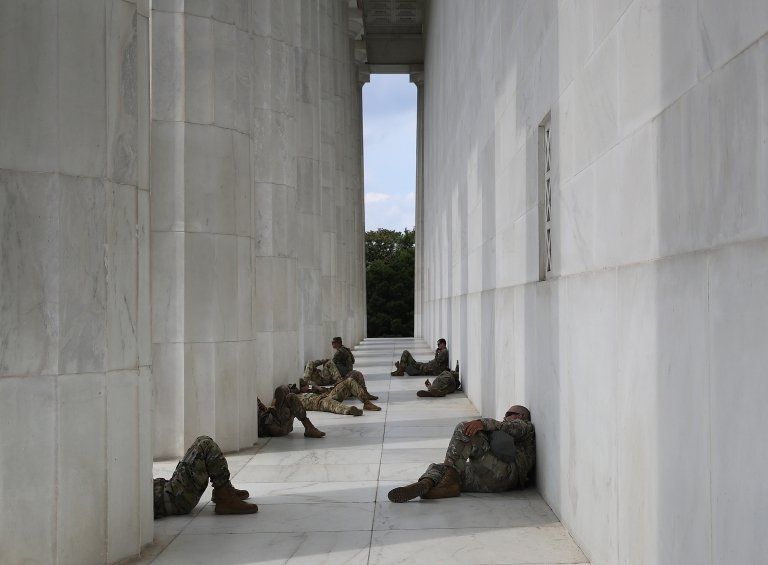 Members of the National Guard take a break from the heat at the Lincoln Memorial while protesters demonstrate against police brutality and racism on June 6, 2020 in Washington, DC
