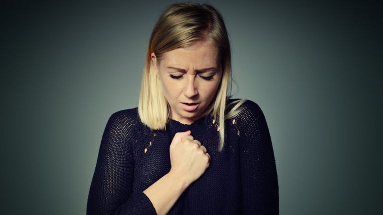 Woman holding her chest