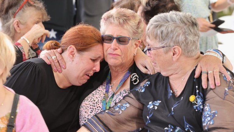 People react during a memorial service to mark the 10th anniversary of the Christchurch earthquake