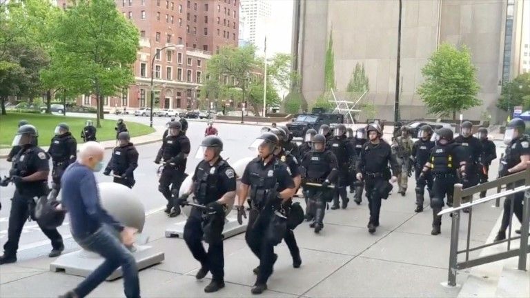 Still image from video of elderly man being pushed by police