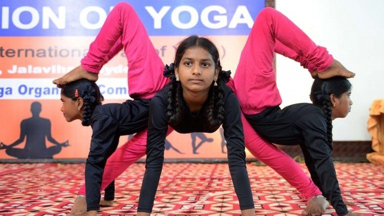 Young Indian girls participate in a yoga convention programme in Hyderabad on June 18, 2015.
