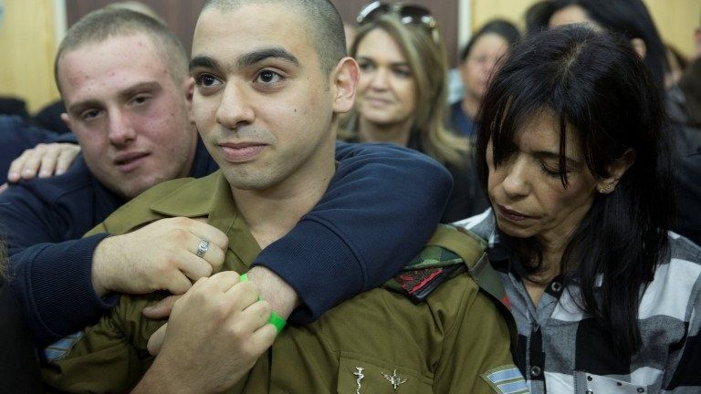 Israeli soldier Elor Azaria, who was caught on video shooting a wounded Palestinian assailant in the head as he lay on the ground, awaits the verdict at a military appeals court in Tel Aviv on 4 January, 2016