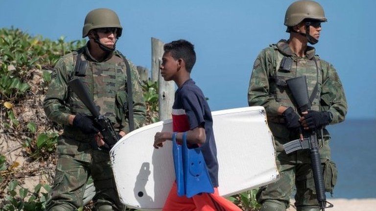 Brazilian Army members stand guard in Ipanema beach on July, 29, 2017