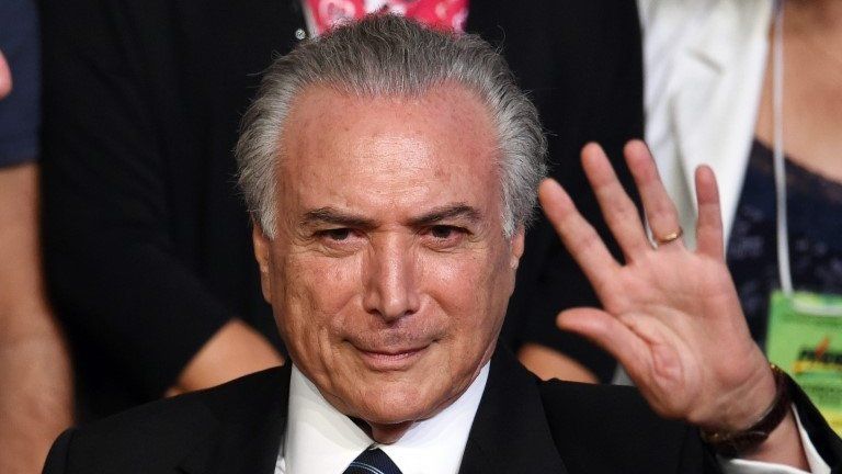 This file photo taken on March 12, 2016 shows Brazilian Vice President Michel Temer waving during the Brazilian Democratic Movement Party (PMDB) national convention in Brasilia, on March 12, 2016.